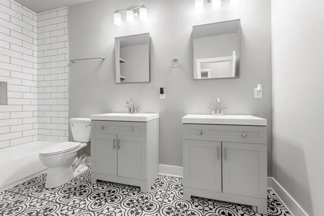 a bathroom with a sink toilet and mirror