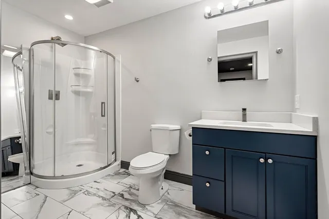 a bathroom with a sink toilet and shower