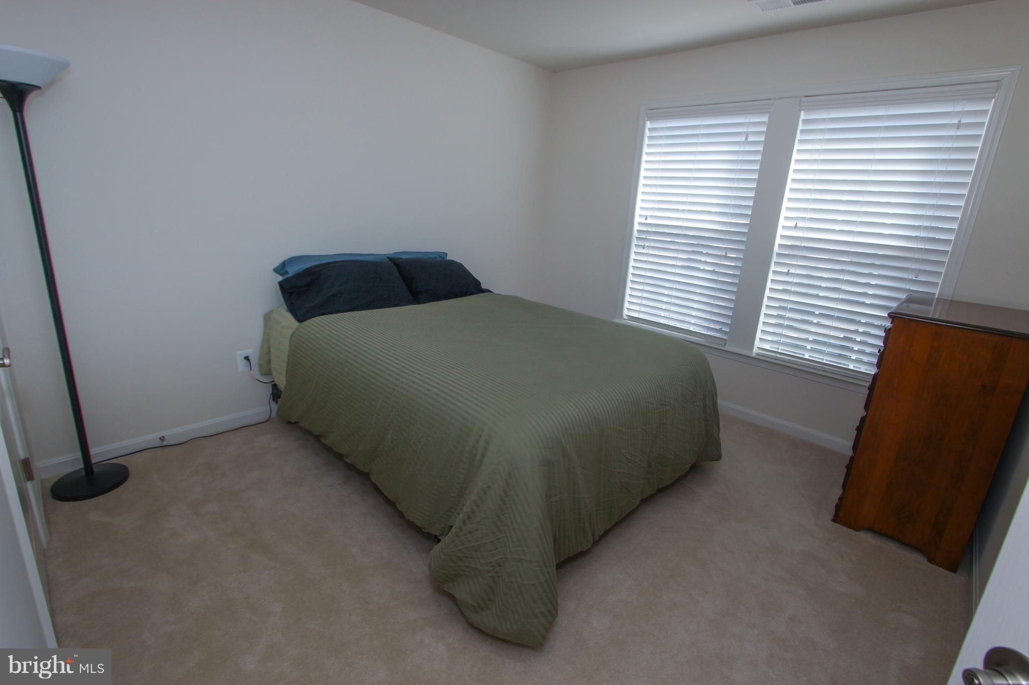 22629 Hawkbill Square Ashburn, VA 20148 - Photo 14 of 30 a bed sitting in a bedroom next to a window