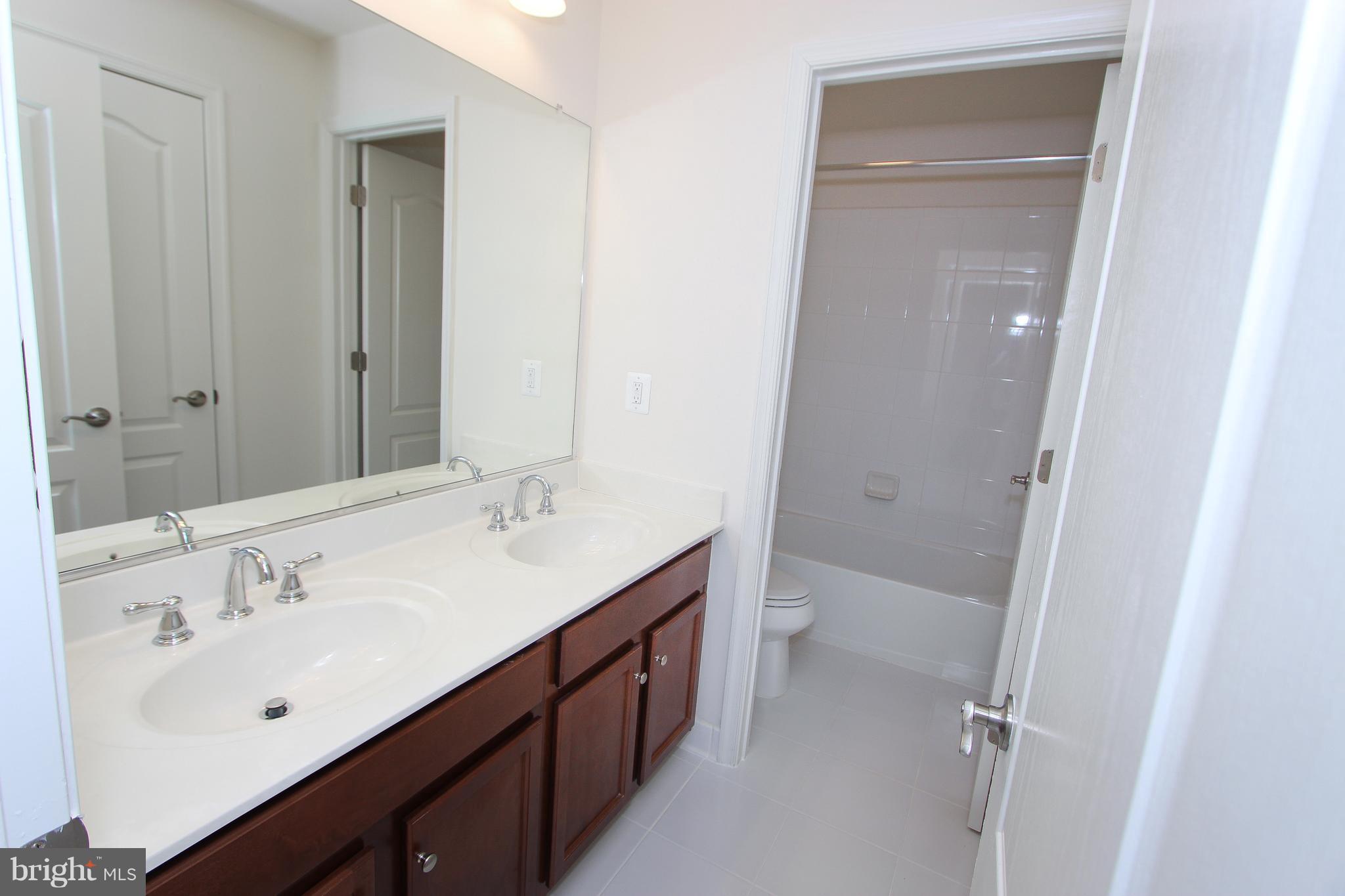 22629 Hawkbill Square Ashburn, VA 20148 - Photo 15 of 30 a bathroom with a double vanity sink mirror and double