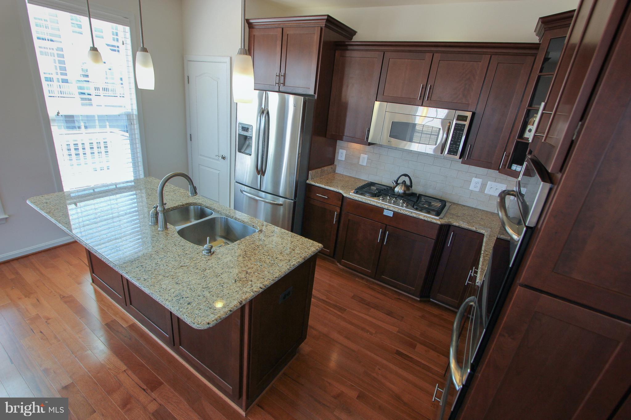 22629 Hawkbill Square Ashburn, VA 20148 - Photo 20 of 30 a kitchen with sink cabinets and refrigerator