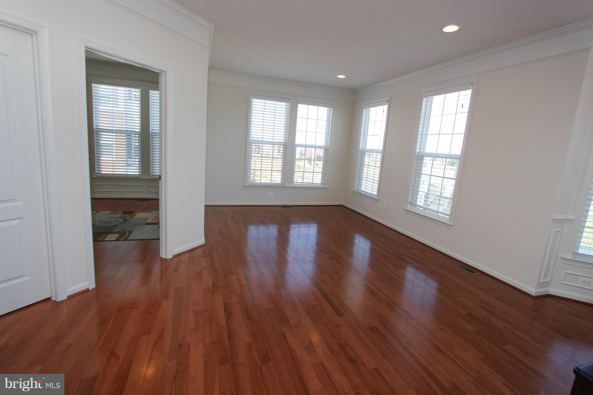 22629 Hawkbill Square Ashburn, VA 20148 - Photo 21 of 30 an empty room with wooden floor and windows