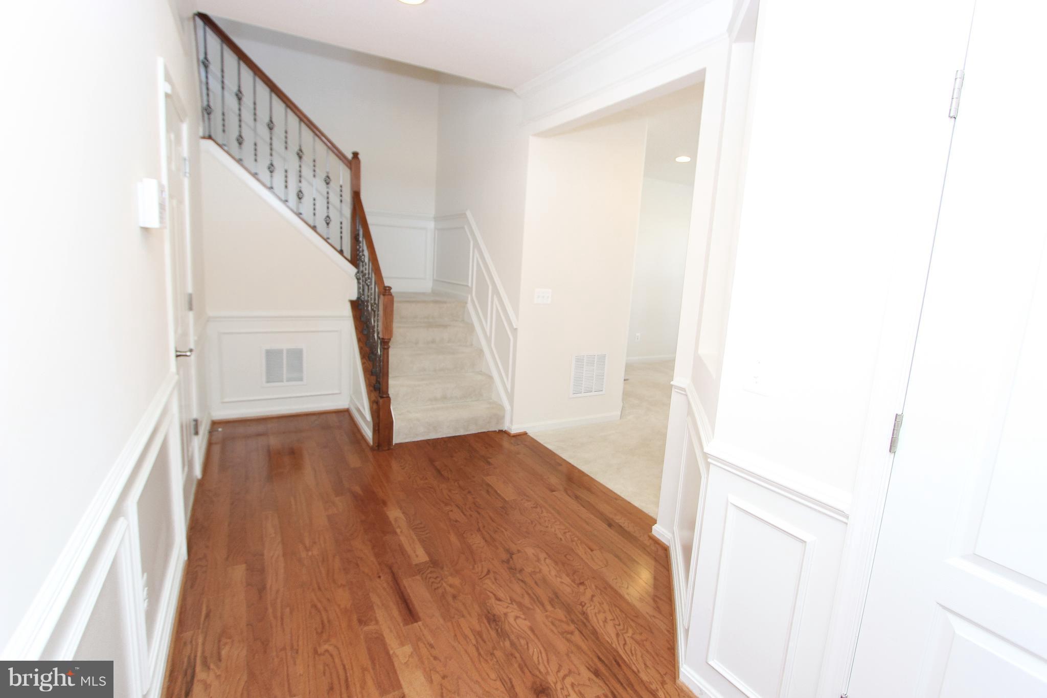 22629 Hawkbill Square Ashburn, VA 20148 - Photo 28 of 30 a view of a hallway with wooden floor and staircase