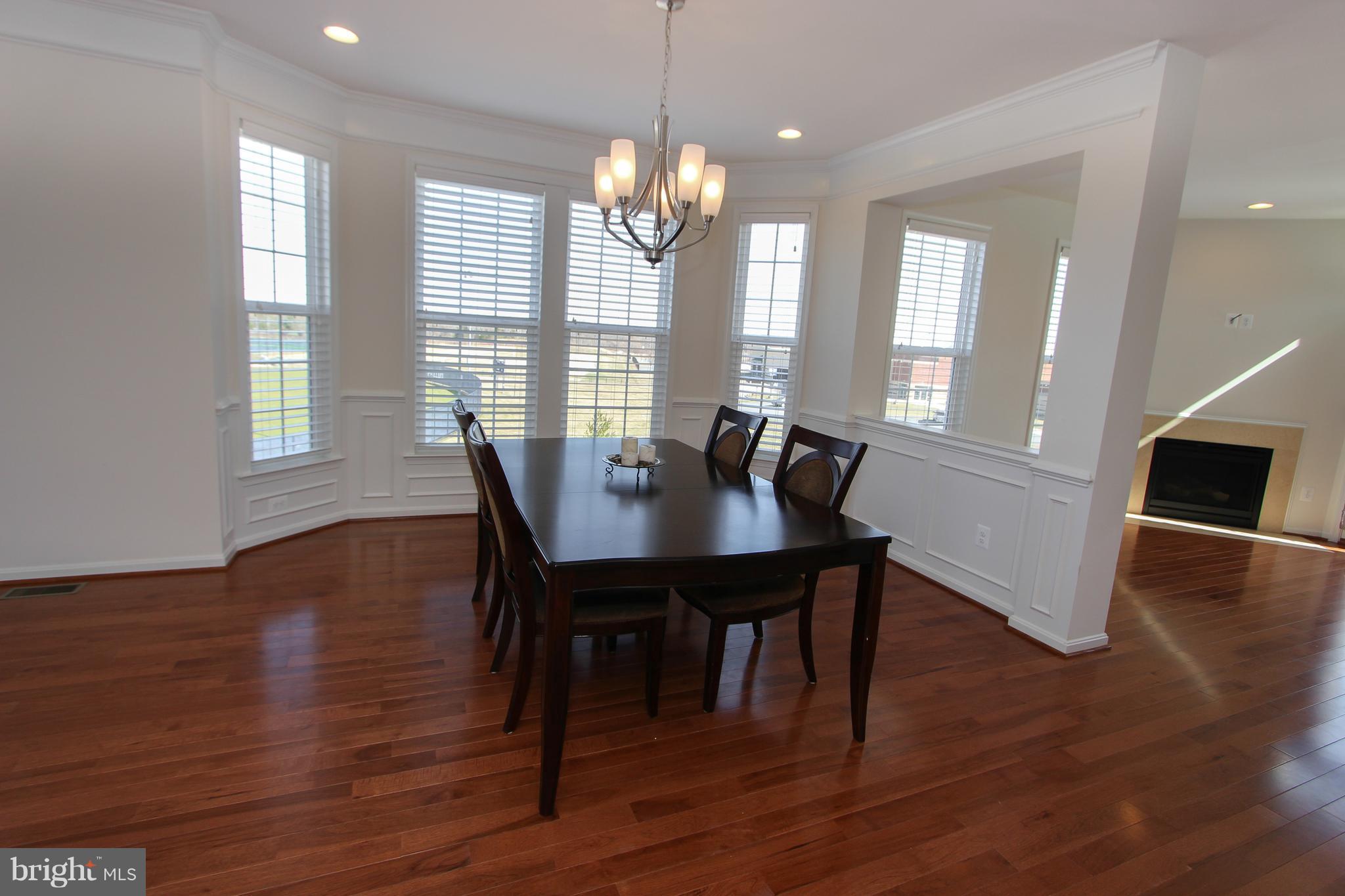 22629 Hawkbill Square Ashburn, VA 20148 - Photo 4 of 30 a view of a dining room with furniture and wooden floor