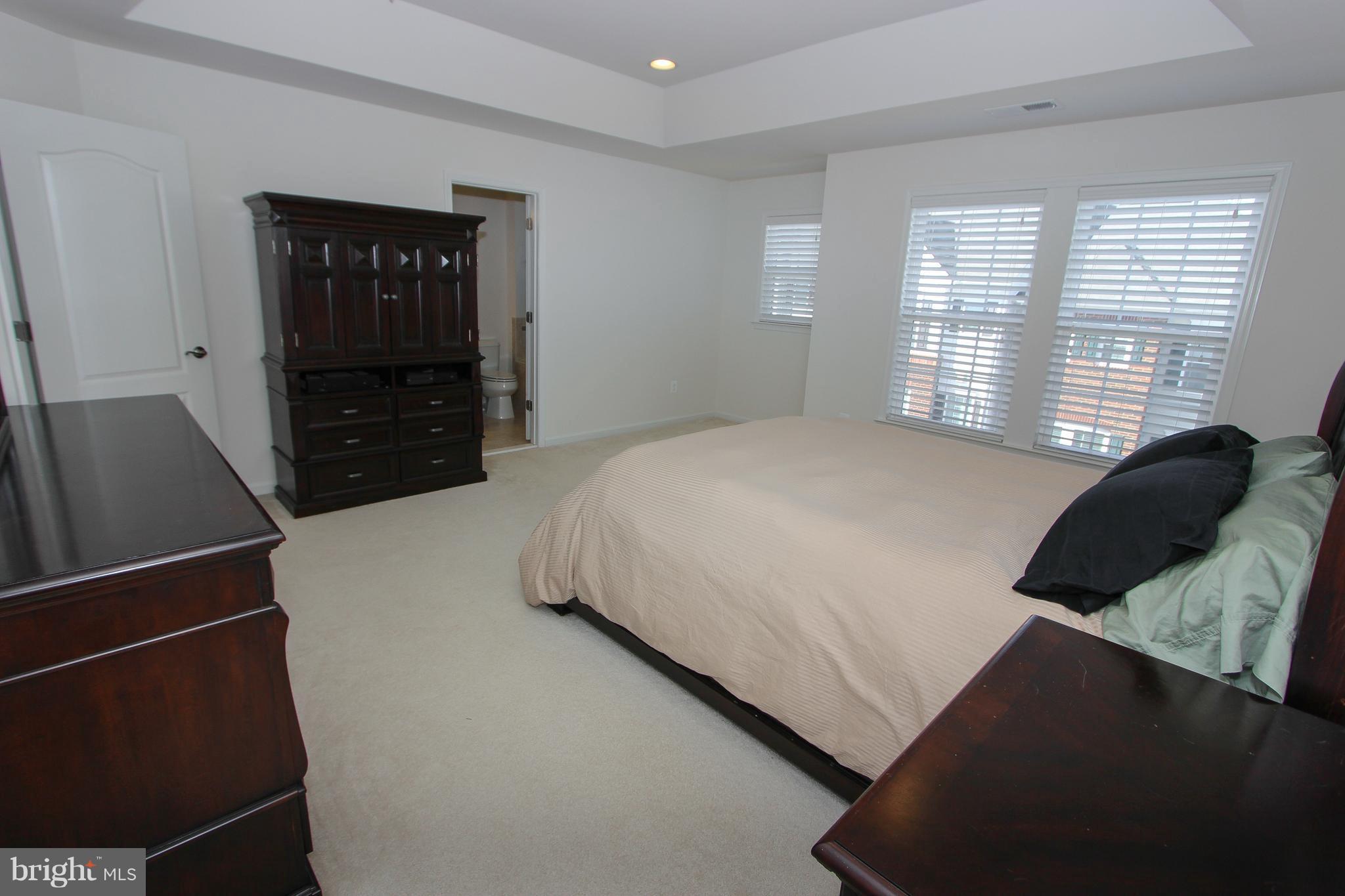 22629 Hawkbill Square Ashburn, VA 20148 - Photo 7 of 30 a bedroom with a bed and a television