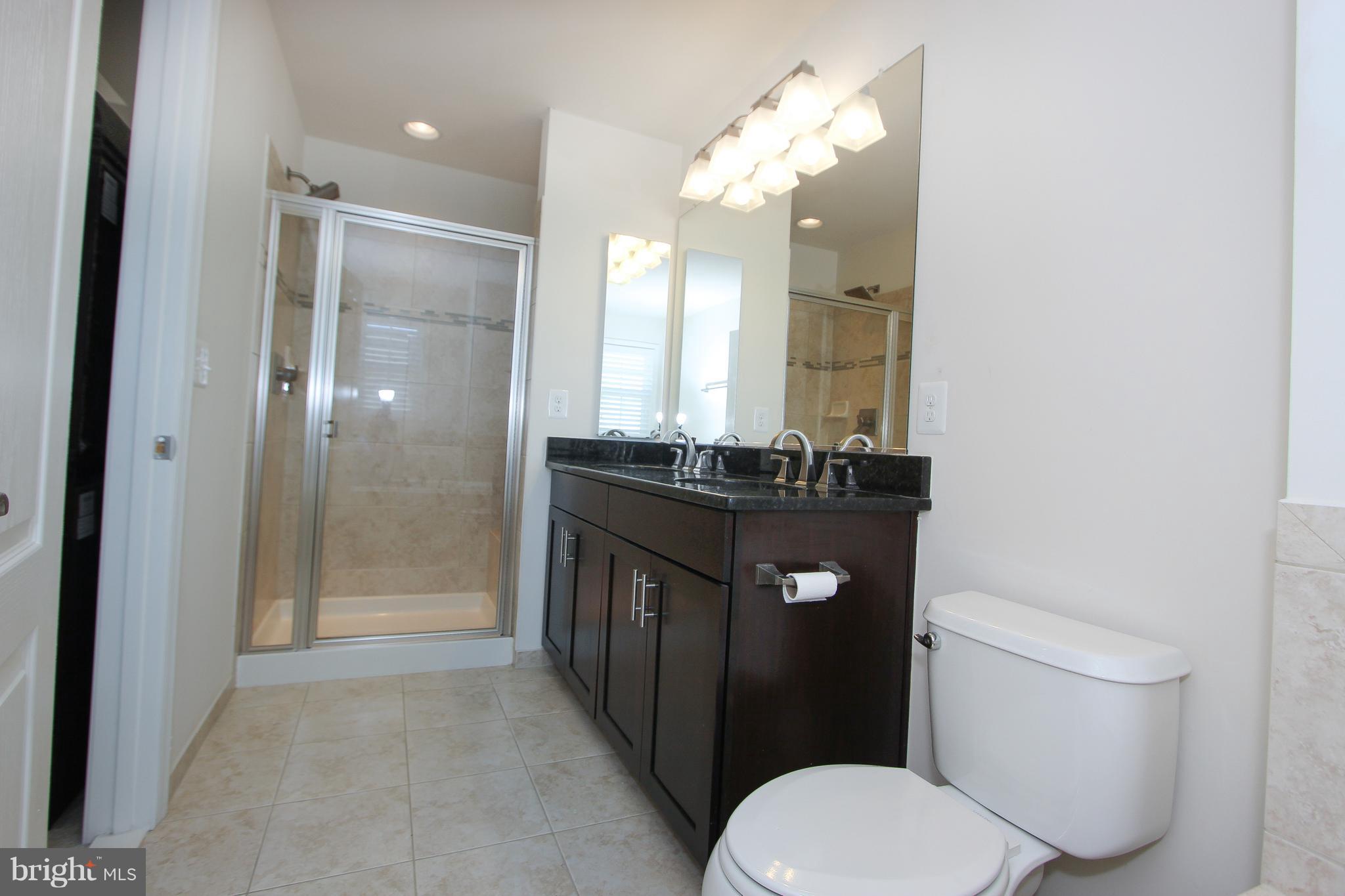 22629 Hawkbill Square Ashburn, VA 20148 - Photo 10 of 30 a bathroom with a granite countertop toilet sink and mirror