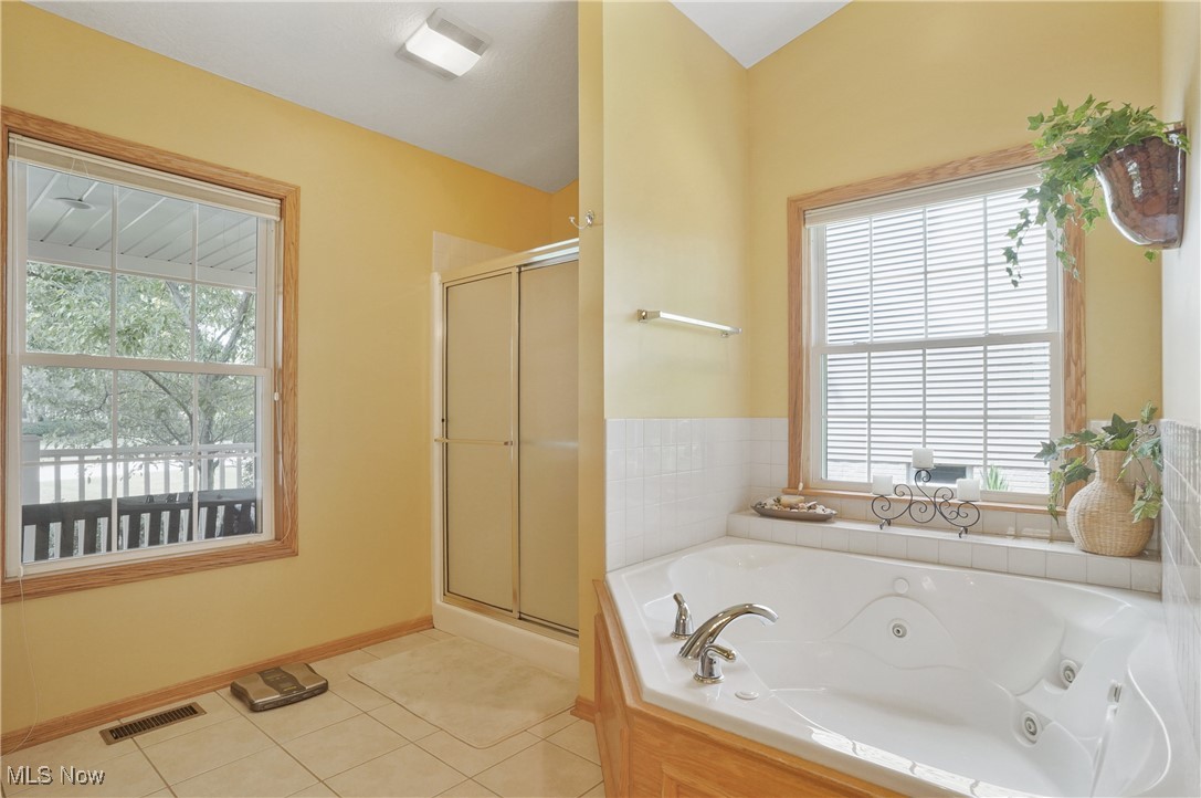 4265 Ridge Crest Drive Akron, OH 44321 - Photo 25 of 49 Bathroom with a stall shower, a whirlpool tub, and tile patterned flooring