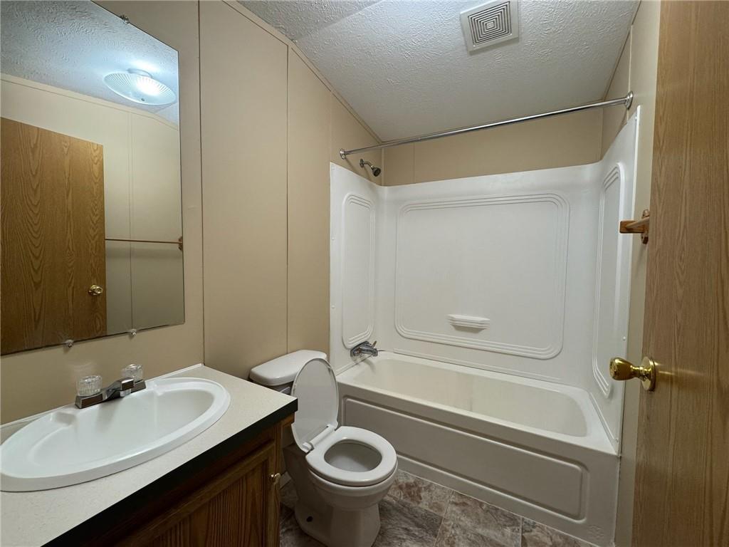 220 Heller Road Butler, PA 16002 - Photo 14 of 17 a bathroom with a sink a toilet and a mirror