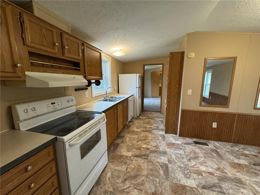 220 Heller Road Butler, PA 16002 - Photo 6 of 17 a kitchen with a stove and a refrigerator