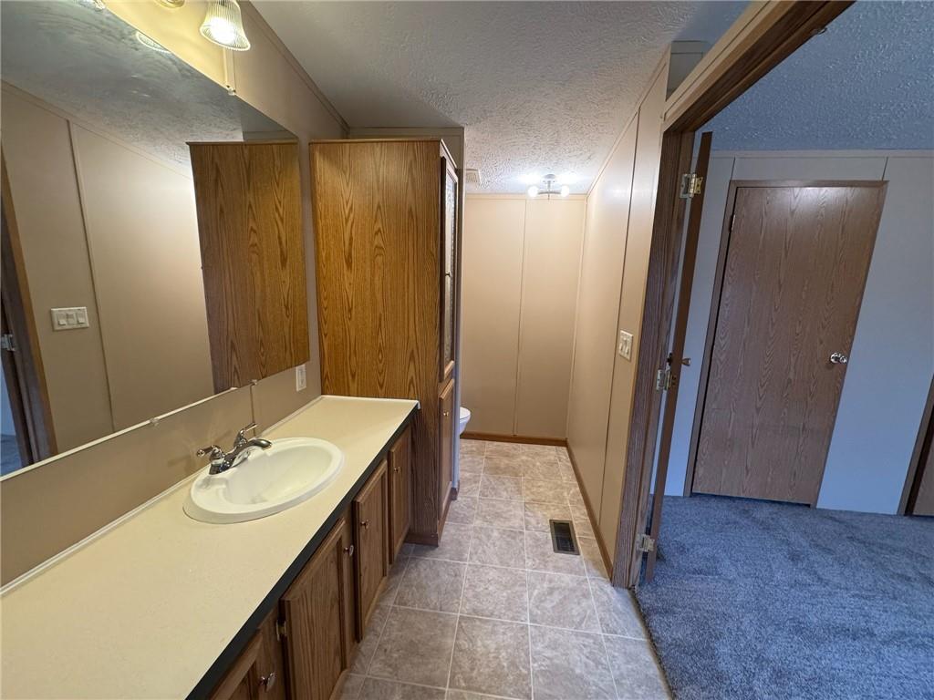 220 Heller Road Butler, PA 16002 - Photo 9 of 17 a bathroom with a sink a mirror and a shower