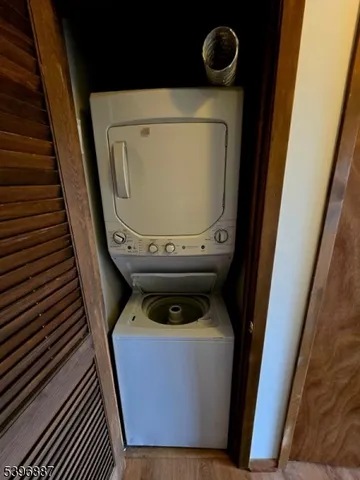 a view of a room with wooden floor and a window