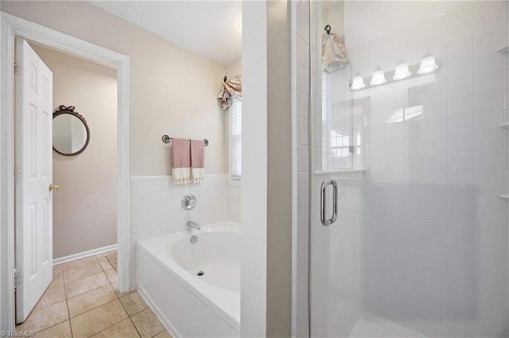 3659 Canopy Oak Court High Point, NC 27265 - Photo 12 of 42 Ensuite primary bathroom with separate shower and garden tub.