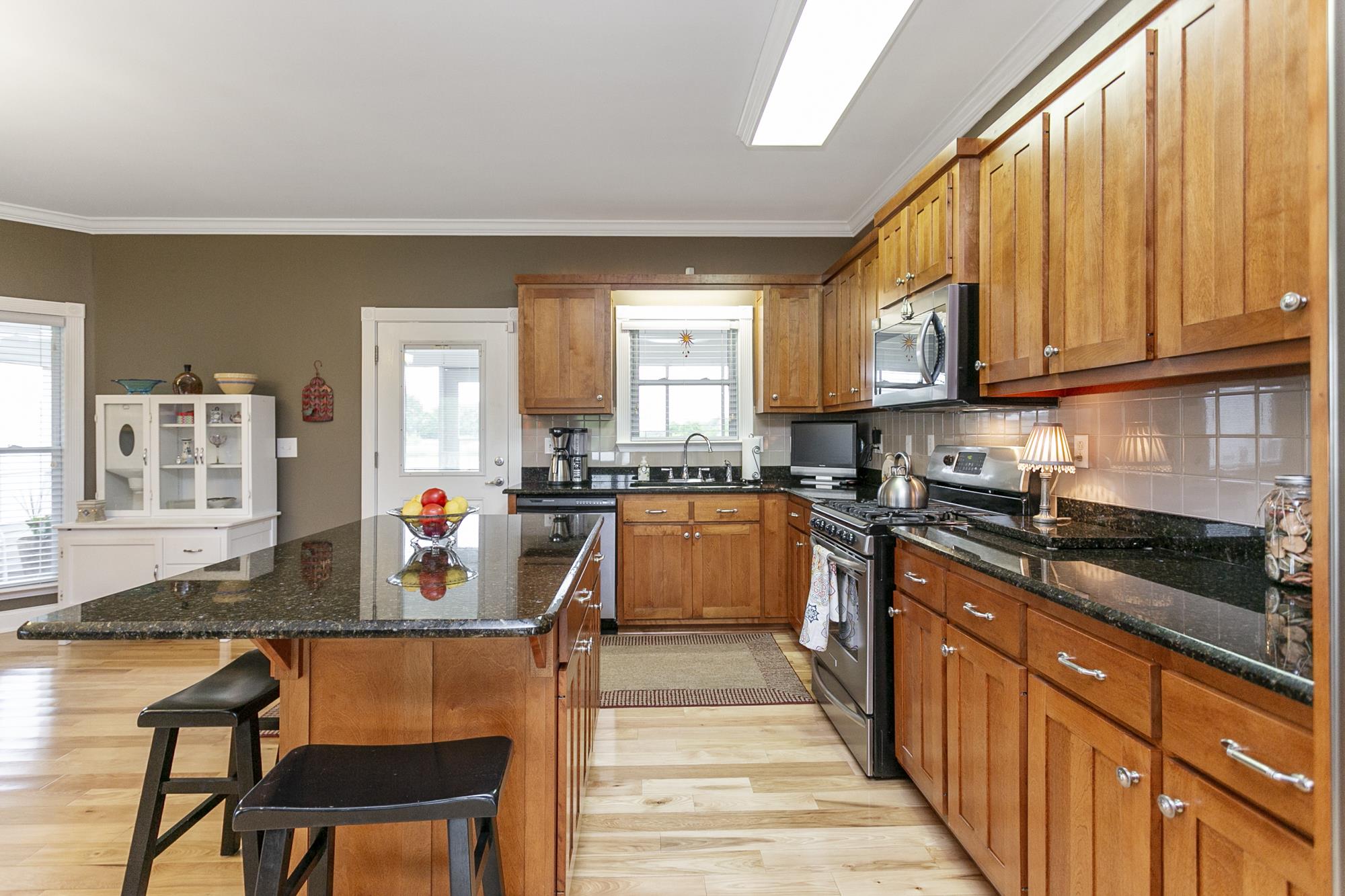 5154 Youngville Road Springfield, TN 37172 - Photo 6 of 30 a kitchen with stainless steel appliances granite countertop a stove top oven a sink dishwasher and cabinets with wooden floor