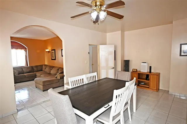 a dining room with furniture and wooden floor