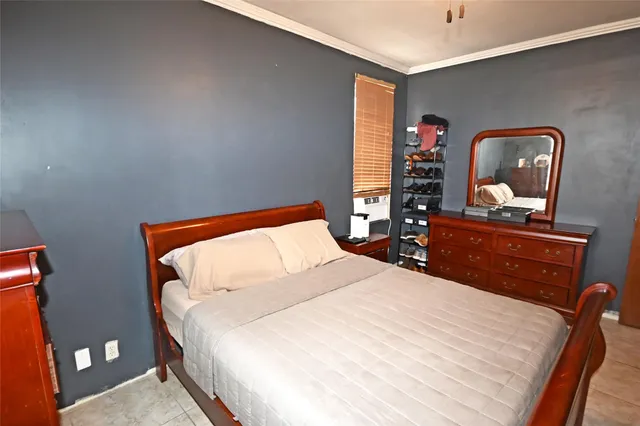 a bed sitting in a bedroom and dresser