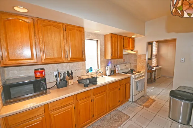 a kitchen with stainless steel appliances a sink cabinets and wooden floor