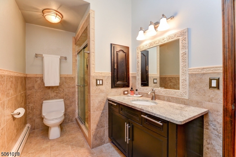 600 North Monroe Street Ridgewood, NJ 07450 - Photo 13 of 18 a bathroom with a toilet sink and mirror
