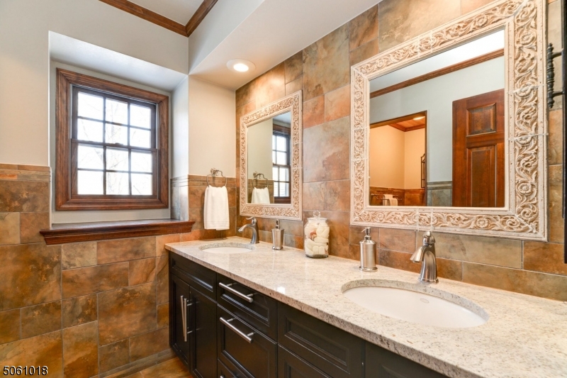 600 North Monroe Street Ridgewood, NJ 07450 - Photo 16 of 18 a bathroom with a granite countertop sink and a large mirror