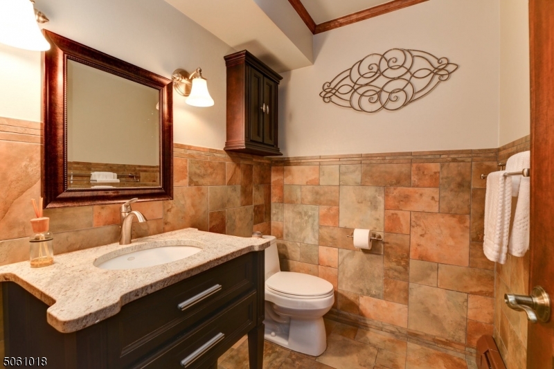 600 North Monroe Street Ridgewood, NJ 07450 - Photo 9 of 18 a bathroom with a granite countertop sink toilet and mirror
