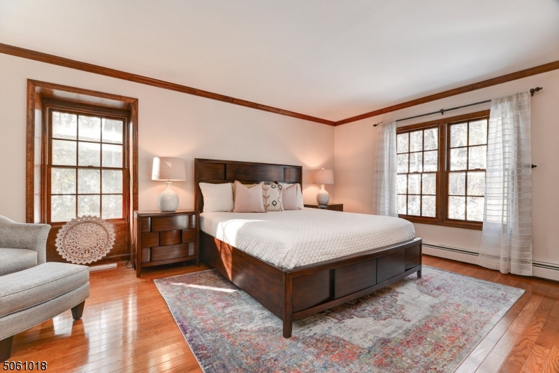600 North Monroe Street Ridgewood, NJ 07450 - Photo 10 of 18 a spacious bedroom with a bed and glass window