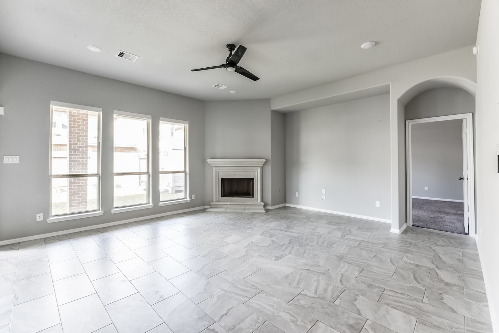 1118 Mysterium Lane Rosenberg, TX 77469 - Photo 20 of 38 Open family room with high ceilings and a striking cast-stone fireplace, ideal for gathering and relaxing.