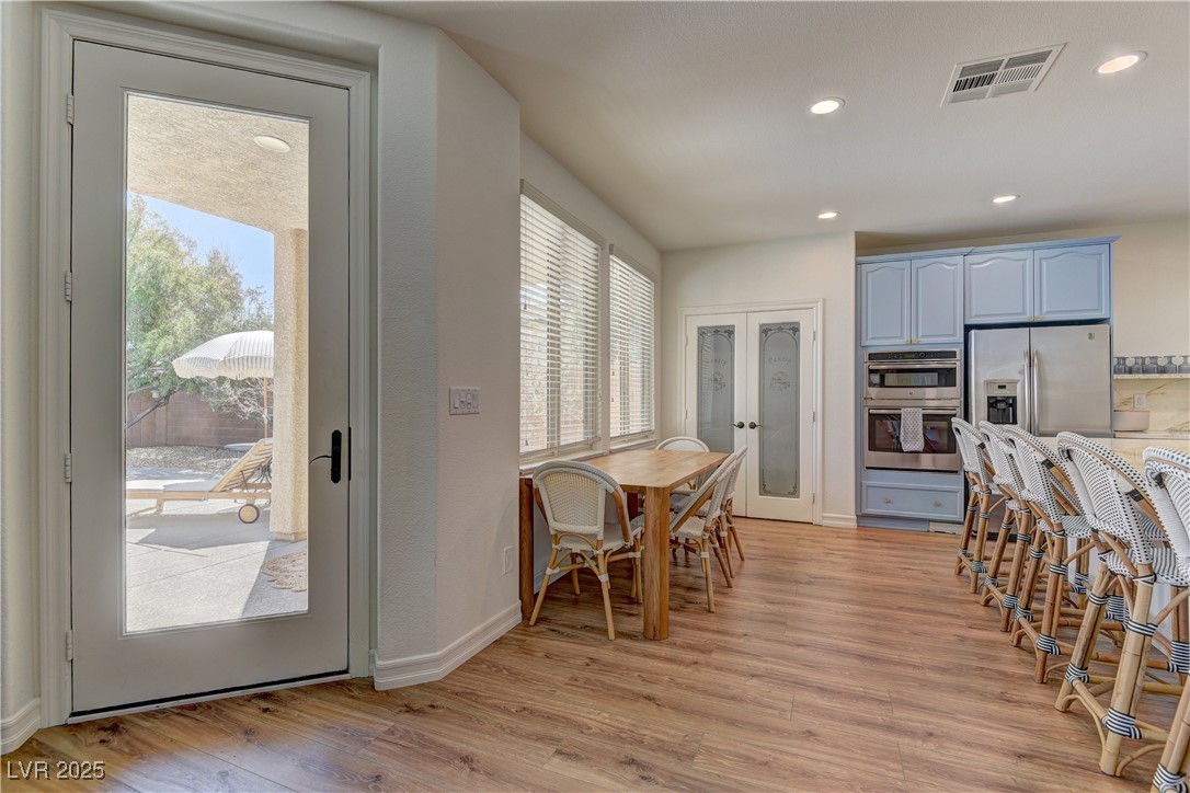 9992 South Sky Parlor Road Las Vegas, NV 89178 - Photo 11 of 42 Dining area with light wood-style floors, french doors, visible vents, and recessed lighting