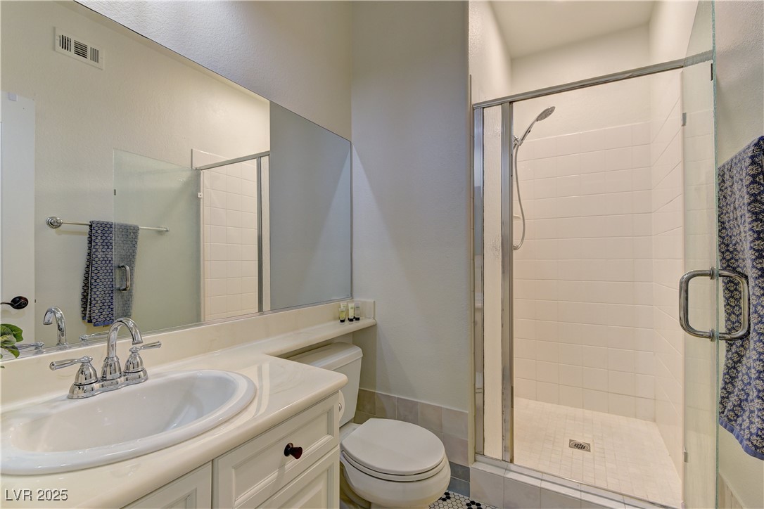 9992 South Sky Parlor Road Las Vegas, NV 89178 - Photo 18 of 42 Bathroom featuring a shower stall, vanity, visible vents, and toilet