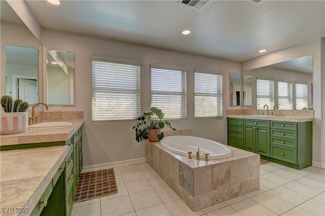 9992 South Sky Parlor Road Las Vegas, NV 89178 - Photo 25 of 42 Full bathroom with a sink, visible vents, two vanities, and a garden tub