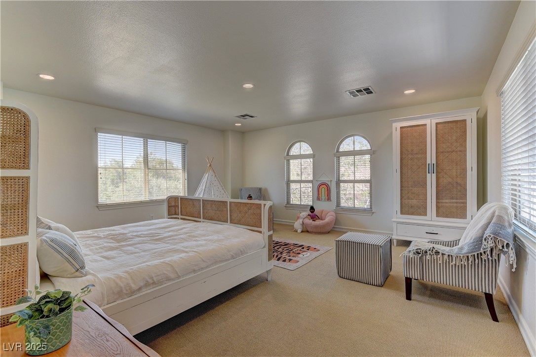 9992 South Sky Parlor Road Las Vegas, NV 89178 - Photo 28 of 42 Bedroom featuring visible vents, multiple windows, and carpet floors