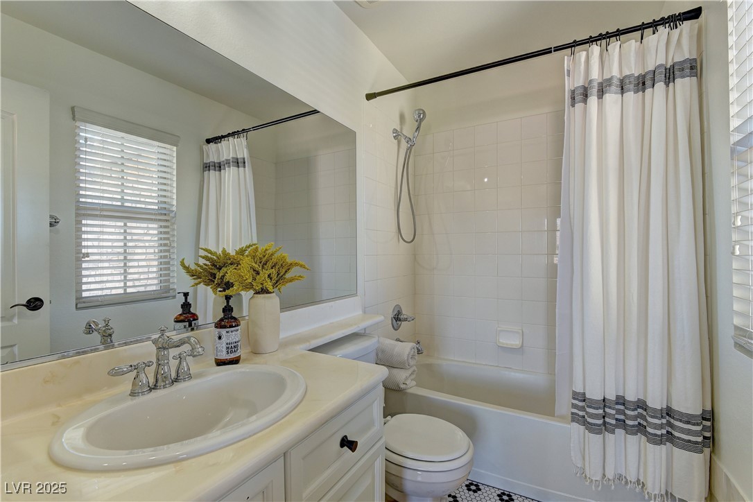 9992 South Sky Parlor Road Las Vegas, NV 89178 - Photo 33 of 42 Full bath featuring toilet, vanity, and shower / tub combo with curtain