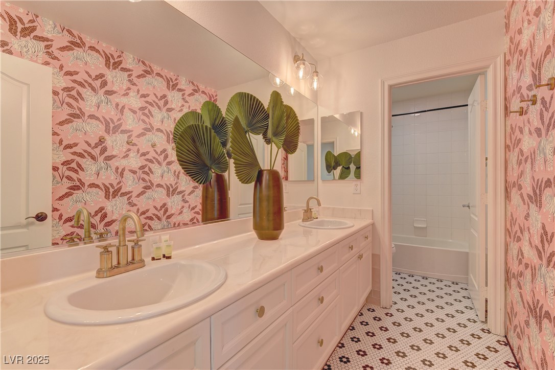 9992 South Sky Parlor Road Las Vegas, NV 89178 - Photo 34 of 42 Bathroom featuring wallpapered walls, double vanity, and a sink