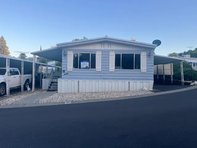 a view of a house next to a yard