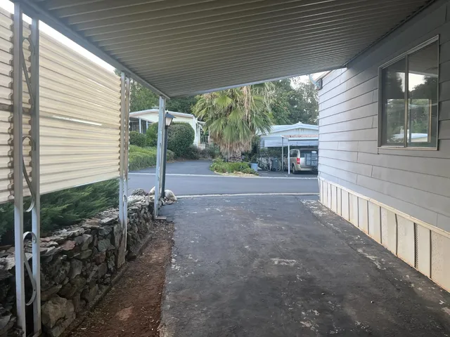a view of a house with backyard and porch