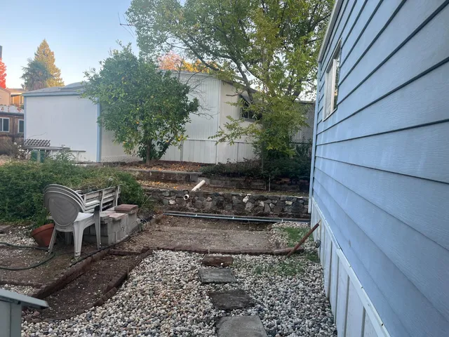 a view of a backyard with sitting area