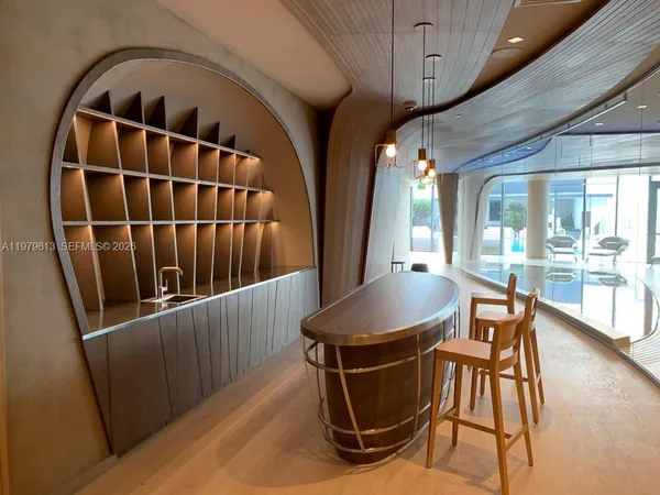 a living room with furniture and a floor to ceiling window