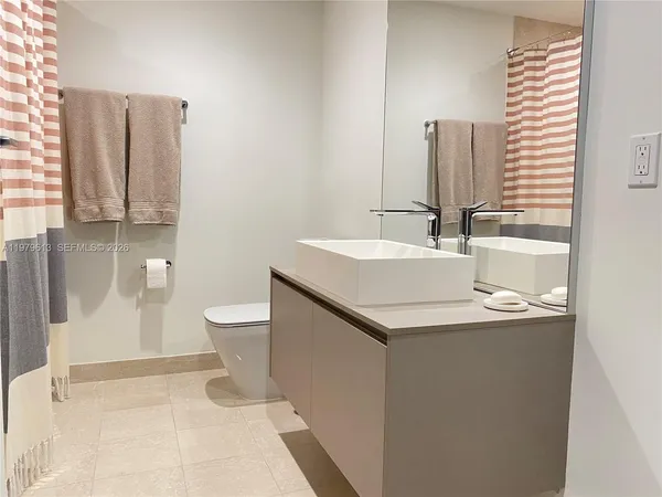 a bathroom with a sink toilet and mirror