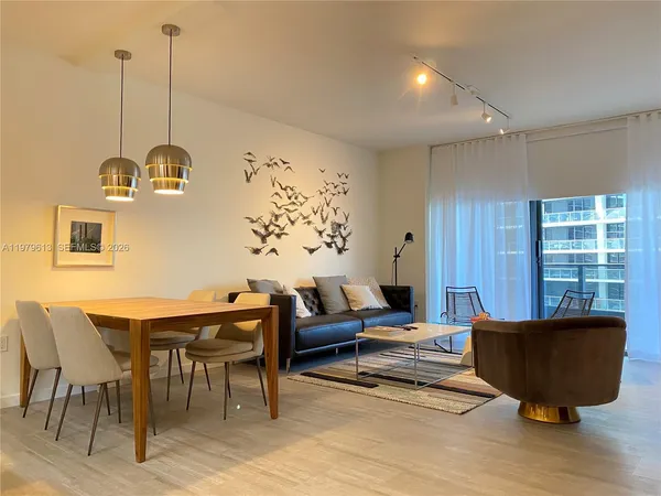 a living room with furniture a window and a dining table