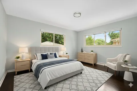 a bedroom with a bed a mirror and a large window