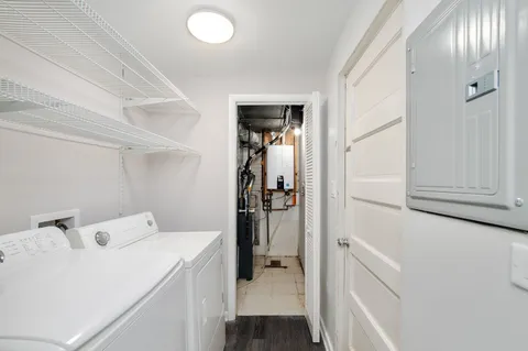 a view of a yard with house and tree in the background