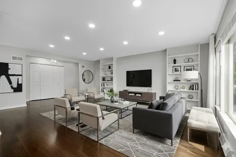 a living room with fireplace furniture and a flat screen tv