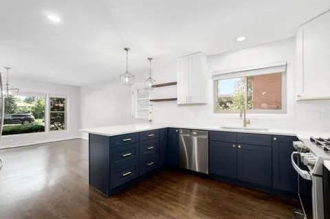 a kitchen with stainless steel appliances granite countertop a sink and stove top oven
