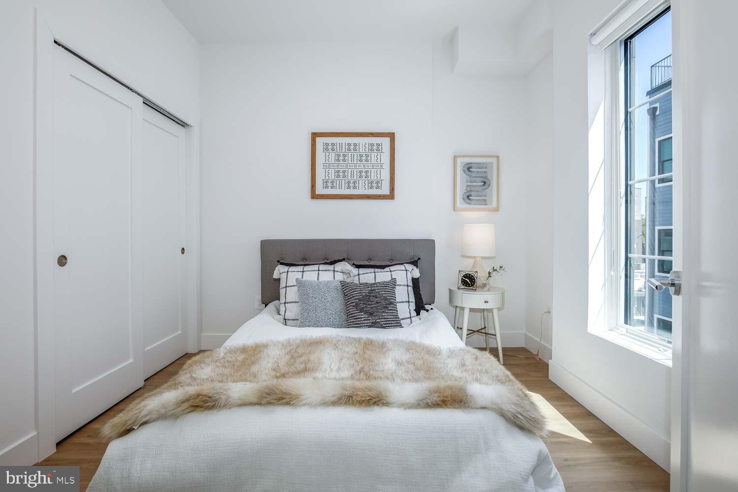 2310 4th Street Northeast, Unit 4 Washington, DC 20002 - Photo 9 of 17 a large bed sitting in a bedroom next to a window