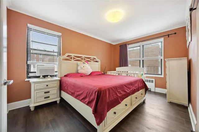 a large bed sitting in a bedroom next to a window