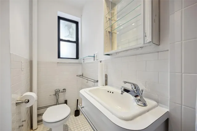 a bathroom with a sink a toilet and mirror