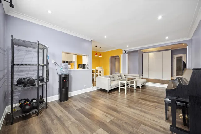 a view of a a dining room with furniture window and wooden floor