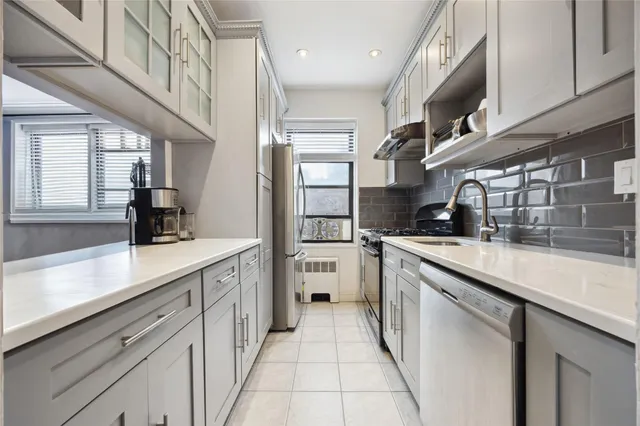 a kitchen with cabinets and window