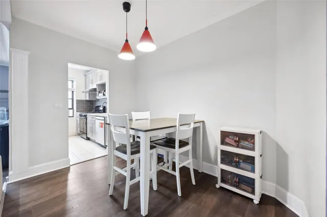 a view of a workspace with furniture and wooden floor