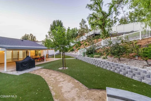 a view of a chair and table in the garden