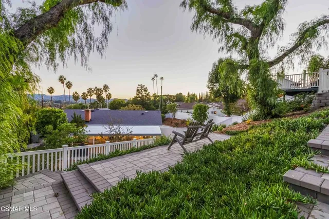 a view of a backyard with sitting area