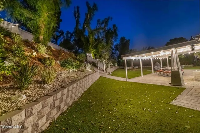 a view of a yard with wooden deck